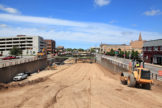 Construction equipment such as steam rollers and trucks are working to reconstruct the Inner Loop East.