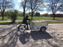 Photo of woman riding e-cargo bike