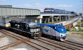 Photo of two train locomotives, one with a bike rack on the front