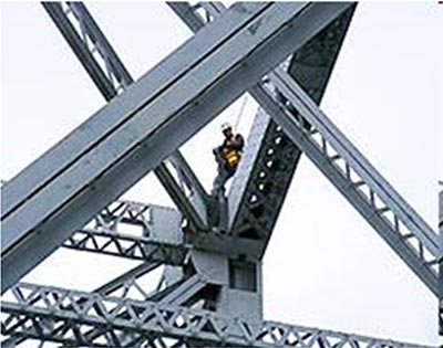 an image of an inspector on a steel truss superstructure.