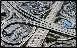Picture 6. Graphic. The picture shows a birds-eye view of a major freeway interchange with several on/off ramps.
