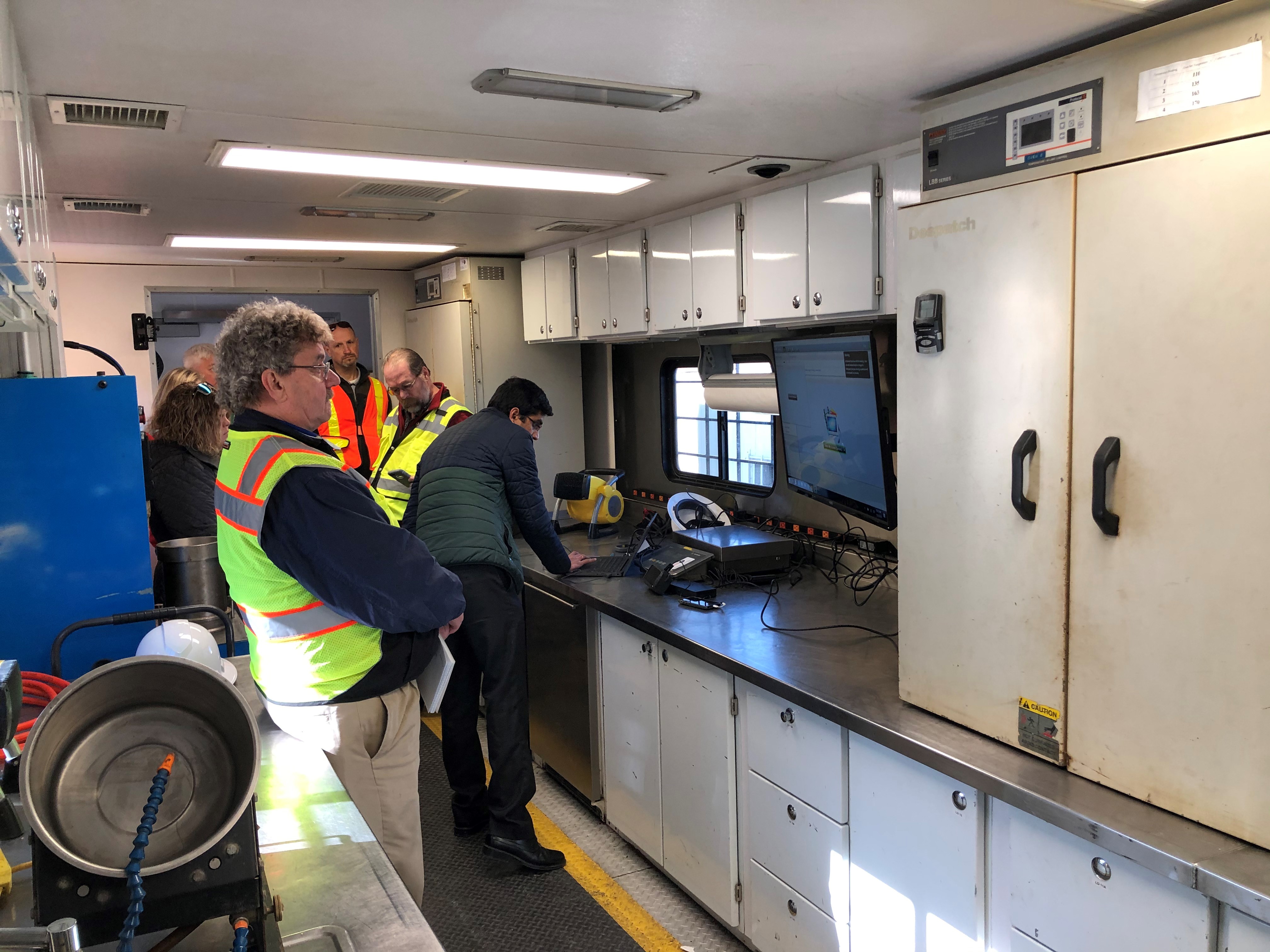Group of workers inside a mobile technology center.