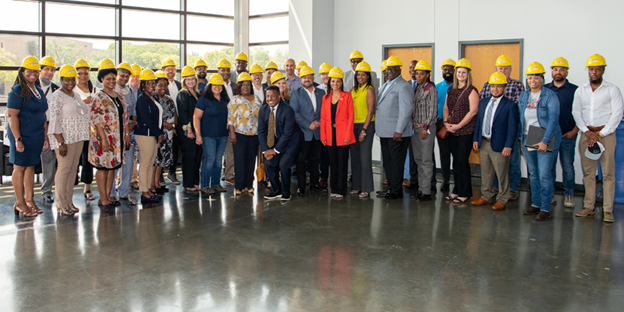 Group of people wearing yellow hard hats
