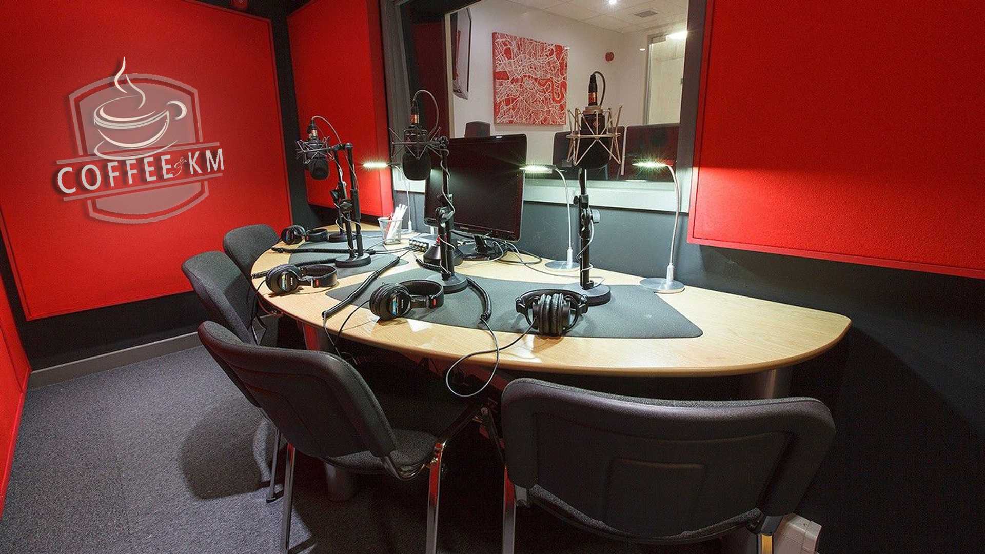 The Coffee & KM Teams background of a  red recording studio.