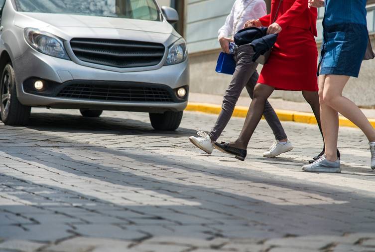 3 people crossing the street.