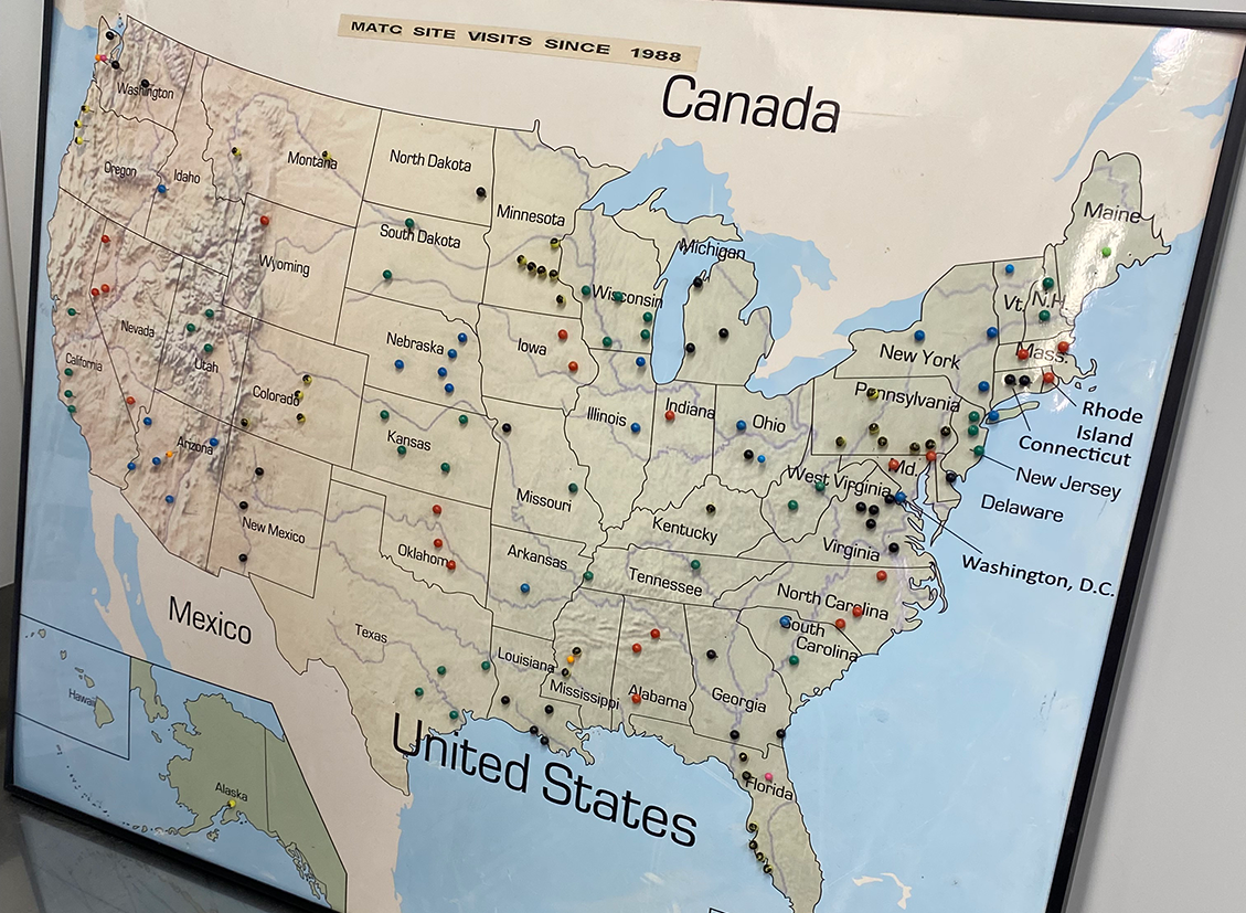 A map of the USA on poster board that has stick pins in it showing locations where the FHWA MATC has done site visits in the past.