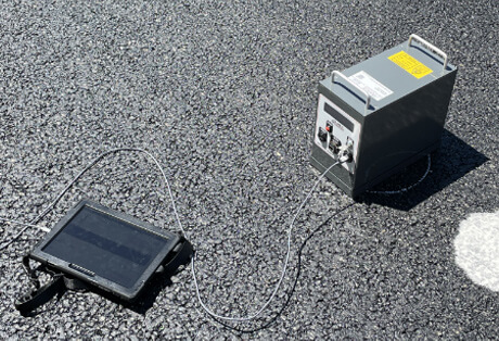 Non-Contact Laser-Based Texture Scanner being used on new asphalt