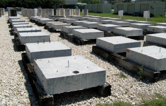 This image shows an outdoor exposure site containing many different concrete specimens, including bridge deck, column and slab elements.