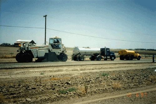 Figure 17-13. Recycler with water and asphalt tanker.