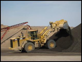 A front-end loader is used to periodically blend the RAP stockpile.