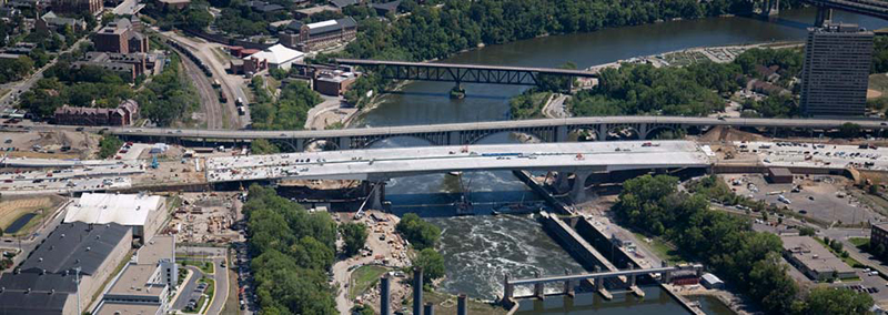 Aerial view of a highway interchange crossing over a river.