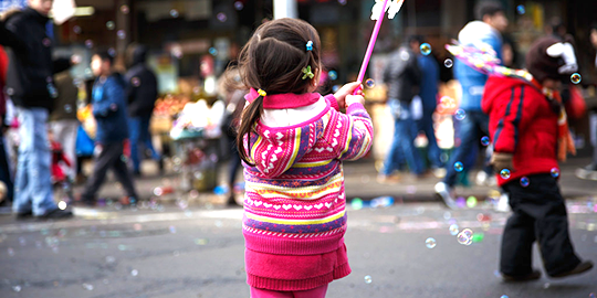 Young girl playing in the street.