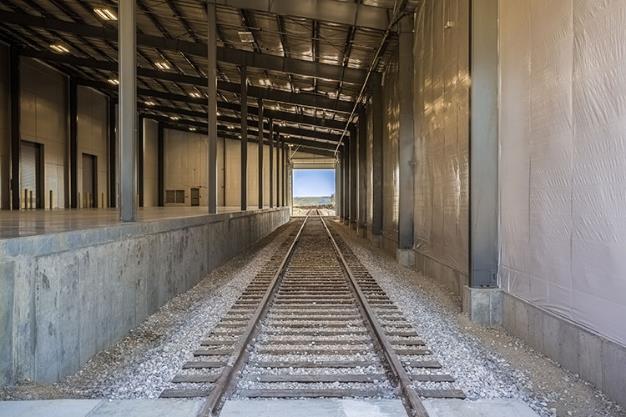 Photo showing railroad track and rail unloading platform inside of new Washington I-69 Cross-dock Facility.