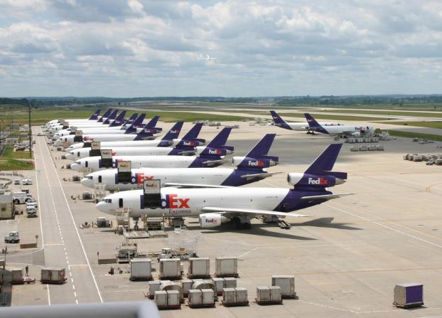 Photo showing 15 FedEx cargo aircraft being loaded with freight at Indianapolis International Airport.