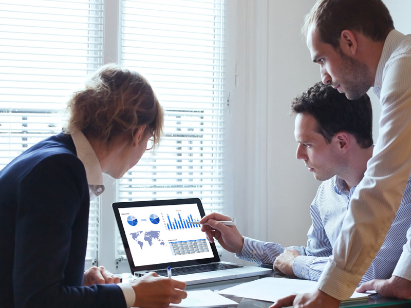 people looking at data on computer