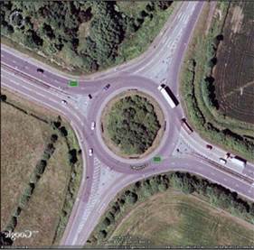 aerial view of 4 lanes entering a traffic circle