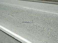 Figure 4.91 shows an example of moderate severity longitudinal cracking on a roadway with a jointed concrete pavement (JCP) surface.