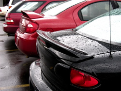 A row of cars in a parking lot