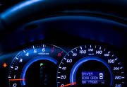 Lighted display of a car dashboard's speedometer, tachometer and gear status.