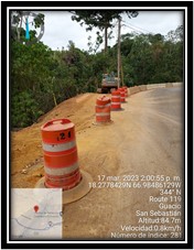 Orange and white barrels on a road where the improvement are made.