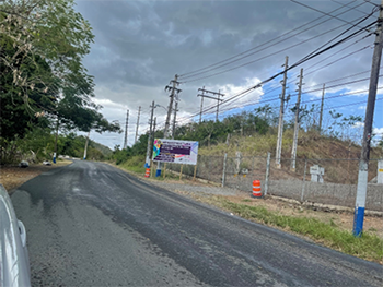 Top of the Bridge Road under repair. On the right side is a sign describing the project.