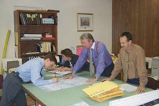 Photo for Utility Records Research - four people at a large desk