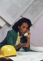Photo: Woman on phone looking at plans