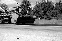 Between 1992 and 1996, preventive maintenance treatments, such as the chip sealing shown here, saved Michigan DOT an estimated $700 million.