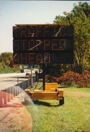 Digital road sign showing that traffic is stopped ahead.