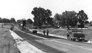 Photo of construction crew paving a road