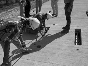 Crew putting post-tensioning strands in place