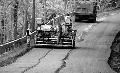 Stretch of road being pulverized and an aggregate base is added