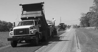 Chip seal being applied to road