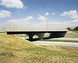 A sideview photo of Skyline Bridge in Omaha, NE that features a full-width bridge deck made of Self-Consolidating Concrete
