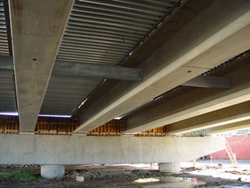 A photo of Eight prestressed SCC beams that were used in one span of the new Pamunkey River bridge near Richmond, VA.