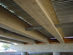 A photo of Eight prestressed SCC beams that were used in one span of the new Pamunkey River bridge near Richmond, VA.