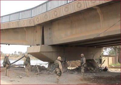 photo of four people under a damaged bridge