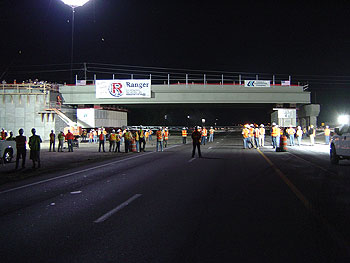 A nighttime photo of the installation of new Graves Avenue Bridge in Florida while the FDOT employees watched