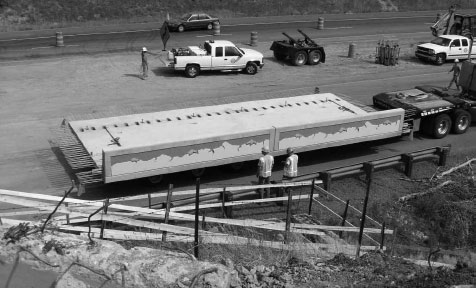 A photo of prefabricated concrete deck panels being transported.