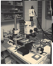 Photo. A close-up view of partially automated linear traverse equipment for determining air-void parameters in concrete.