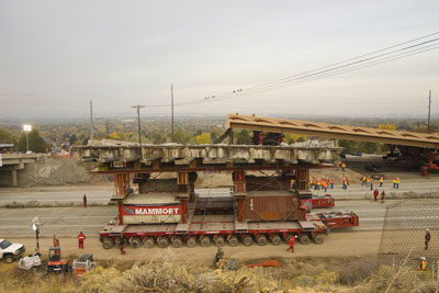 Figure 2. Photo. The old 4500 South bridge is transported on a self-propelled modular transporter on I-215 in Salt Lake City, Utah.