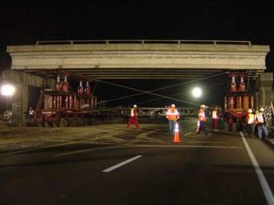 Figure 5. Photo. The old Graves Avenue bridge in Volusia County, Florida, is jacked up on a self-propelled modular transporter.