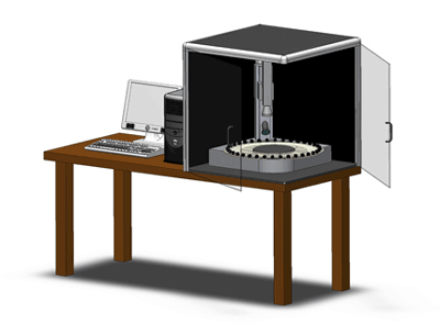 Figure 5. Photo. A graphical rendering of the Aggregate Imaging Measurement System, which will provide enhanced information on aggregate material properties. The device is in a cabinet on a table, next to a computer and hard drive.