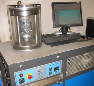 Figure 1. Photo. A close-up view of the Asphalt Mixture Performance Tester (AMPT). The AMPT can be used to evaluate Superpave mixtures.