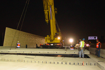 Figure 8. Photo. A view of night-time paving using precast concrete pavements.