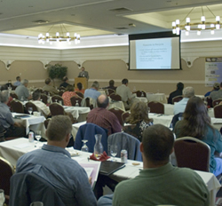 Figure 4. Photo. Participants watch and listen to a presentation at the first Western Region In-Place Recycling Workshop in Salt Lake City, Utah, in June 2008.