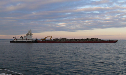 Photo. A load of concrete debris from the old Woodrow Wilson Bridge outside of Washington, DC, is taken by barge to the Dominion Reef at the Gooses in the Chesapeake Bay.