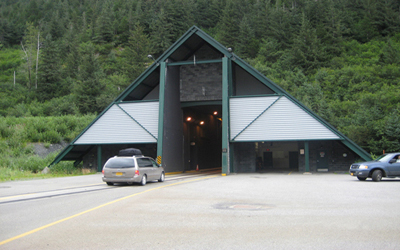 Figure 8. Photo. The entrance to the Anton Anderson Memorial Tunnel in Whittier, Alaska. A minivan is about to enter the tunnel.