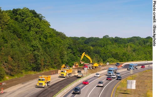 Figure 2. Photo. A view of a work zone in operation on one closed side of a highway. Traffic continues to flow freely in the opposite direction.