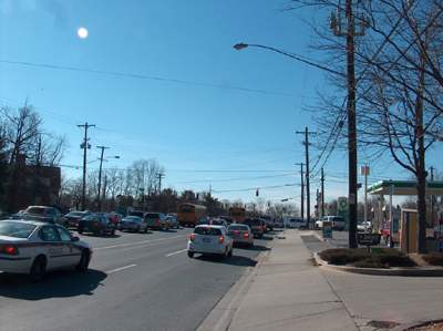 Figure 5. Photo. A street-level view of Maryland Route 97 in Montgomery County, Maryland, showing traffic stopped at a red light.